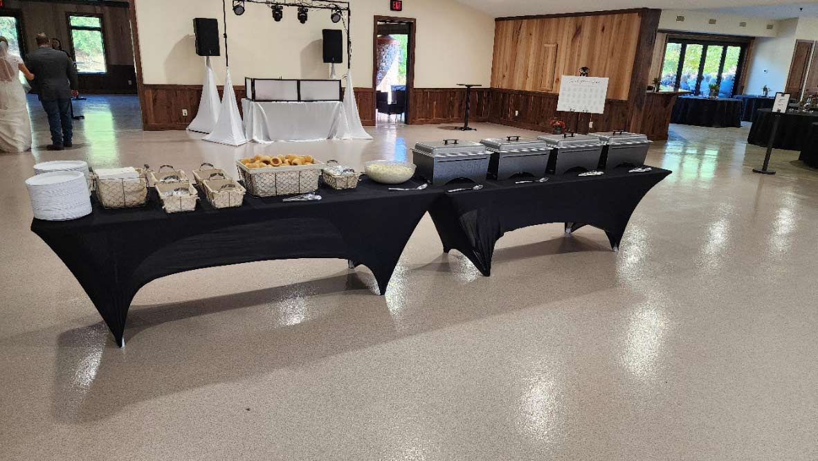 catered food on tables with black cloths